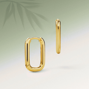 Gold hoop earrings on a gradient background