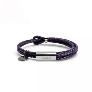Purple braided bracelet with a silver tag on a white background