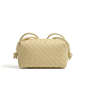 Beige woven handbag on a white background