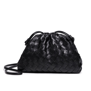 Black woven handbag on a white background
