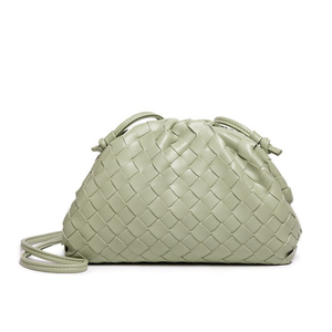 Light green woven handbag on a white background