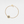 Gold bracelet with a sunflower-shaped charm and projection gemstone on a light gray background