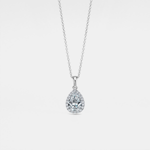 Teardrop-shaped moissanite pendant on a chain against a light gray background