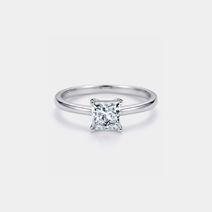 Silver ring with a princess-cut moissanite on a light gray background