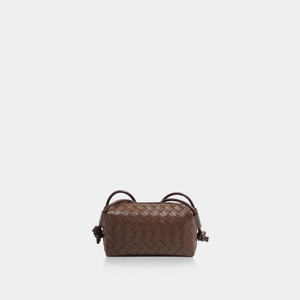 Brown woven handbag on a white background
