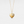 Gold heart-shaped locket pendant with paw print design on a light gray background