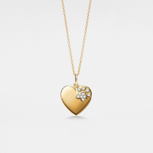 Gold heart-shaped locket pendant with paw print design on a light gray background