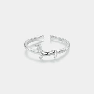 Silver ring with a dachshund dog design on a white background