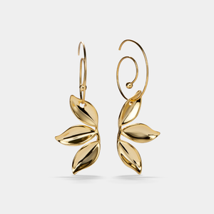 Gold leaf-shaped earrings on a light gray background