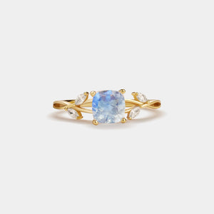 Gold ring with a blue gemstone on a white background