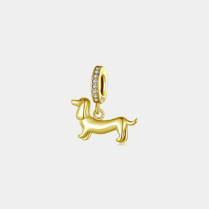 Gold dachshund dog charm pendant with a pavé-set bail, displayed on a white background.