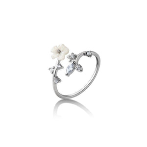 Silver ring with floral design on a white background