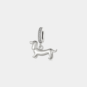Silver dachshund dog charm pendant with a pavé-set bail, displayed on a white background.