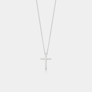 Silver cross necklace on a light gray background