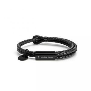 Black braided leather bracelet with a metal tag on a white background
