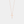 Rose gold cross necklace on a light gray background