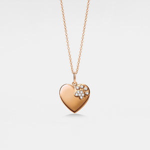 Rose gold heart-shaped locket pendant with paw print design on a light gray background