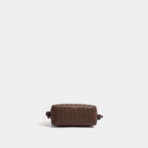 Brown woven pouch on a light beige background