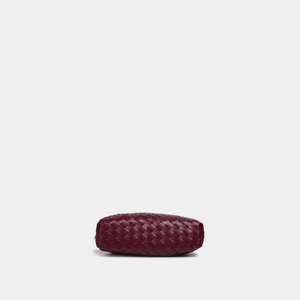 Maroon woven clutch bag on a light gray background