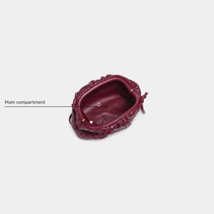 Maroon handbag with decorative patterns on a white background