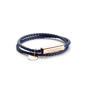 Navy braided bracelet with rose gold tag and heart charm on a white background