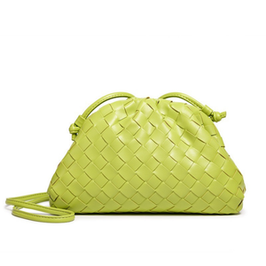 Green woven handbag on a white background