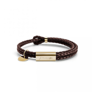 Brown braided leather bracelet with gold tag and heart charm on a white background