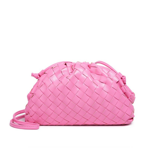 Pink woven handbag on a white background
