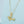 Gold necklace with a dachshund charm on a blue background