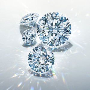 Four diamonds of different sizes on a light gray background