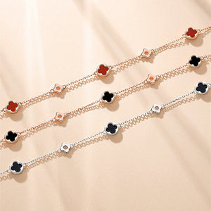 Two floral chain necklaces on a beige fabric background
