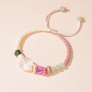 Two matching rope bracelets with silver clasps and green stone accents, displayed on a light background.