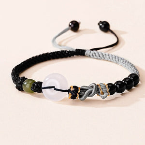 Two matching rope bracelets with silver clasps and green stone accents, displayed on a light background.