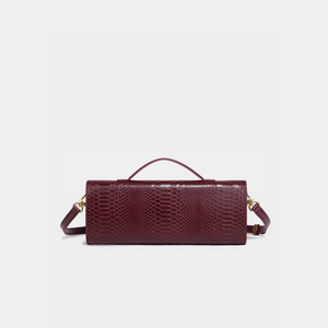 Burgundy handbag with a textured pattern on a light gray background