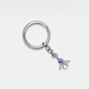 A sterling silver keychain with a gold plating, featuring a small cubic zirconia charm and a gold-colored bee emblem.