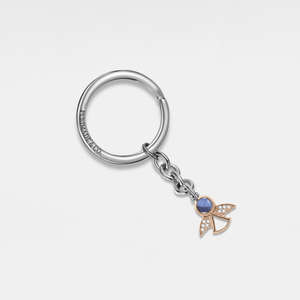 A sterling silver keychain with a gold plating, featuring a small cubic zirconia charm and a gold-colored bee emblem.