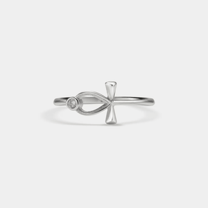 A gold-colored Ankh key of life Egyptian cross ring with a small cubic zirconia on it.