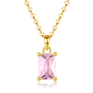 Gold necklace with a pink gemstone pendant on a white background