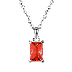 Silver necklace with a red gemstone pendant on a white background