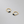 Gold hoop earrings with blue gemstones on a gray background