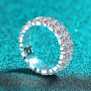 Silver ring with gemstones on a turquoise glittery background