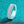 Silver ring with diamond-like stones on a teal glittery background