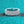 Multi-layered diamond ring on a teal background