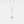 A gold-plated necklace with a vertical rectangular charm featuring a small crystal or pearl on the bottom side, attached to a chain.