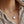 Heart-shaped pearl necklace on a person wearing a striped shirt