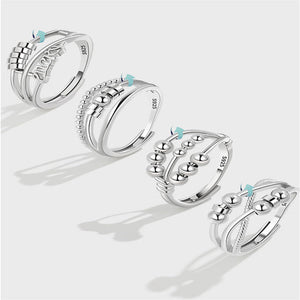 Set of silver rings with turquoise stones on a light gray background