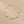 Gold bracelet on a beige background