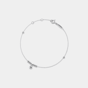 A delicate gold-colored anklet with bell-shaped pendants on a white background.