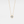 A small round moissanite pendant necklace with a gold chain and a gold setting.
