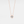 A small round moissanite pendant necklace with a gold chain and a gold setting.